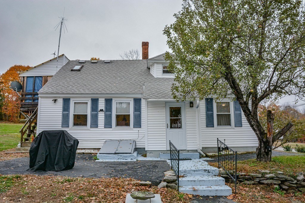 345 Richardson Road Ashby, MA 01431 - Photo 3 of 37 a view of a white house with a large tree and wooden fence