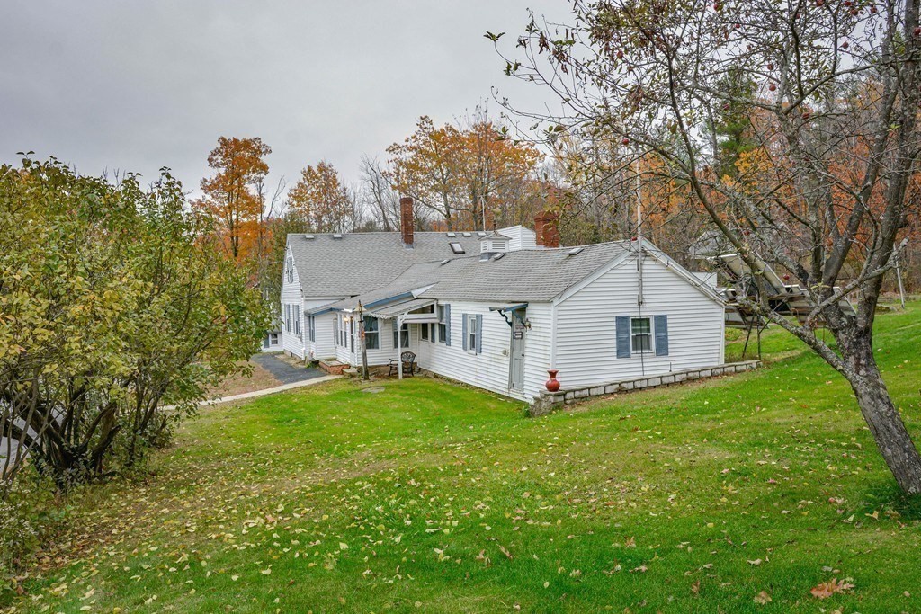 345 Richardson Road Ashby, MA 01431 - Photo 4 of 37 a view of a house with a big yard and large tree