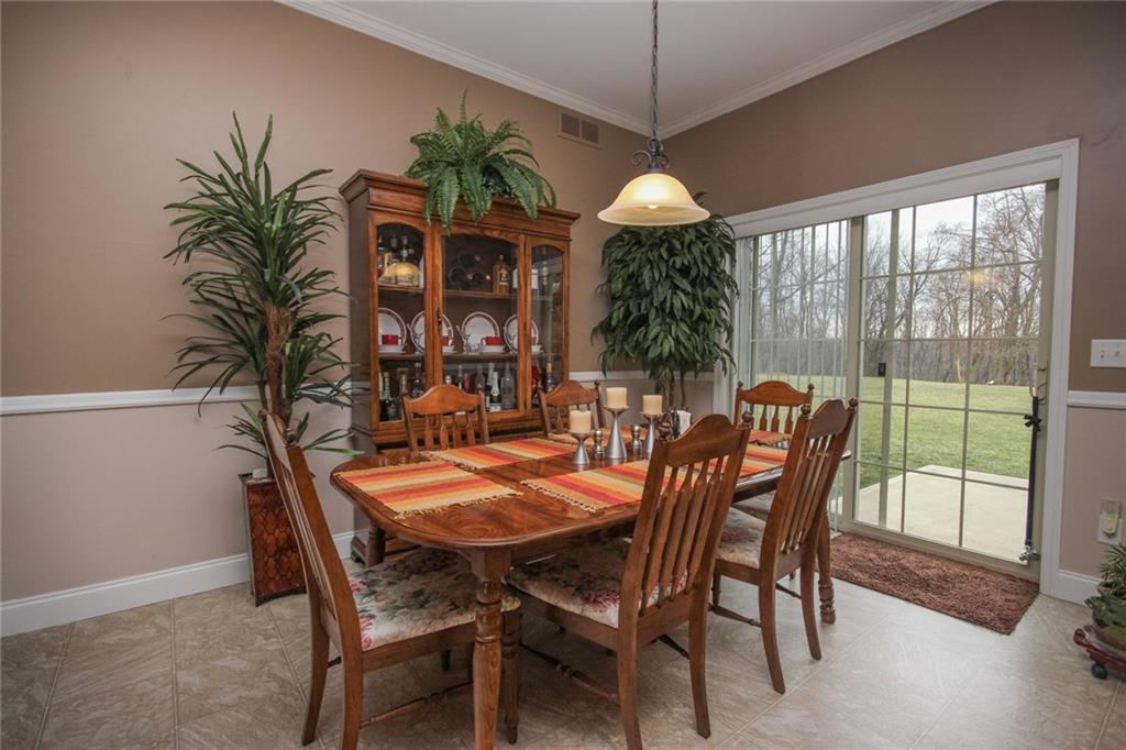 393 Mowry Road Monaca, PA 15061 - Photo 7 of 25 Dining room, with a glimpse of the crown molding and chair rail, access to back patio.