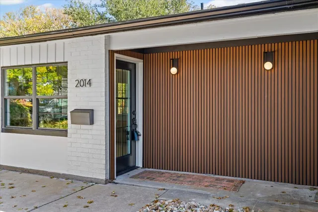 a view of a house with a wooden fence