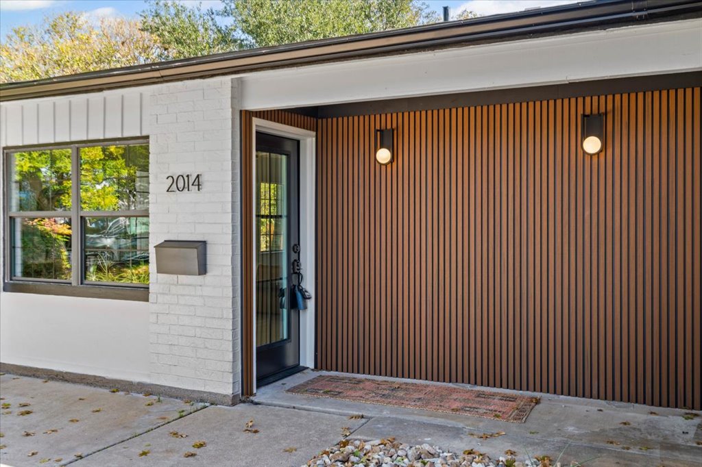 a view of a house with a wooden fence