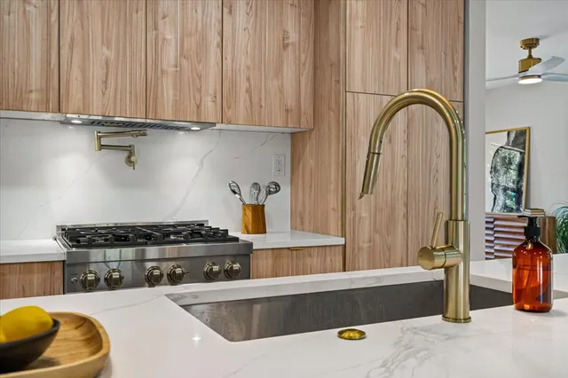 a kitchen with a sink and a stove top oven