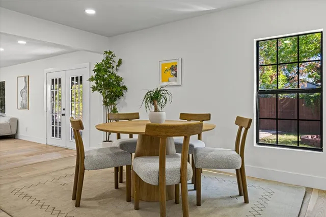 a dining room with furniture and window