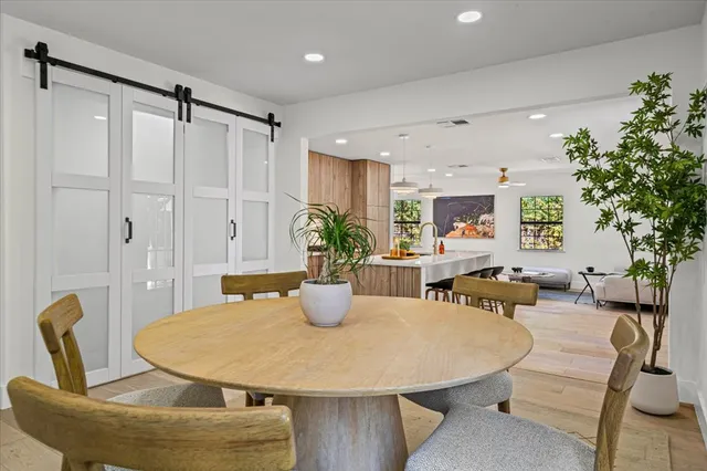 a view of a dining room with furniture and wooden floor