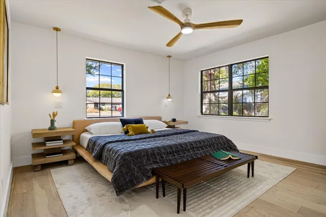 a bedroom with a bed window and a table