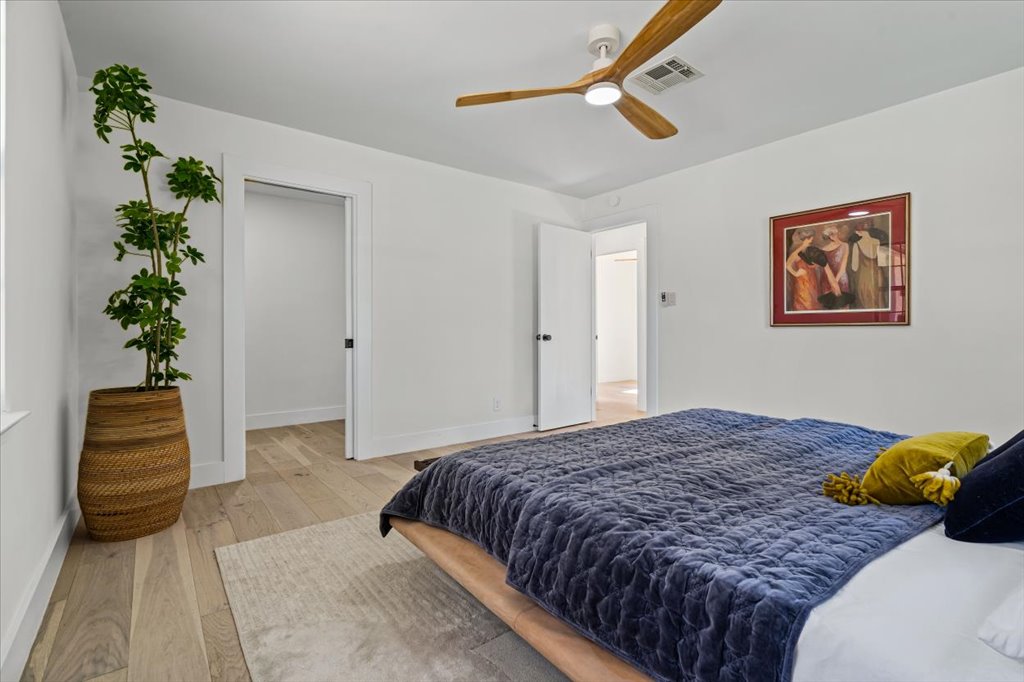 2014 Hardy Circle Austin, TX 78757 - Photo 20 of 34 a bedroom with a bed and a potted plant