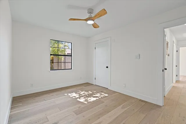 wooden floor in an empty room with a window