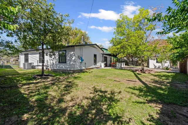a house with huge green field in front of it