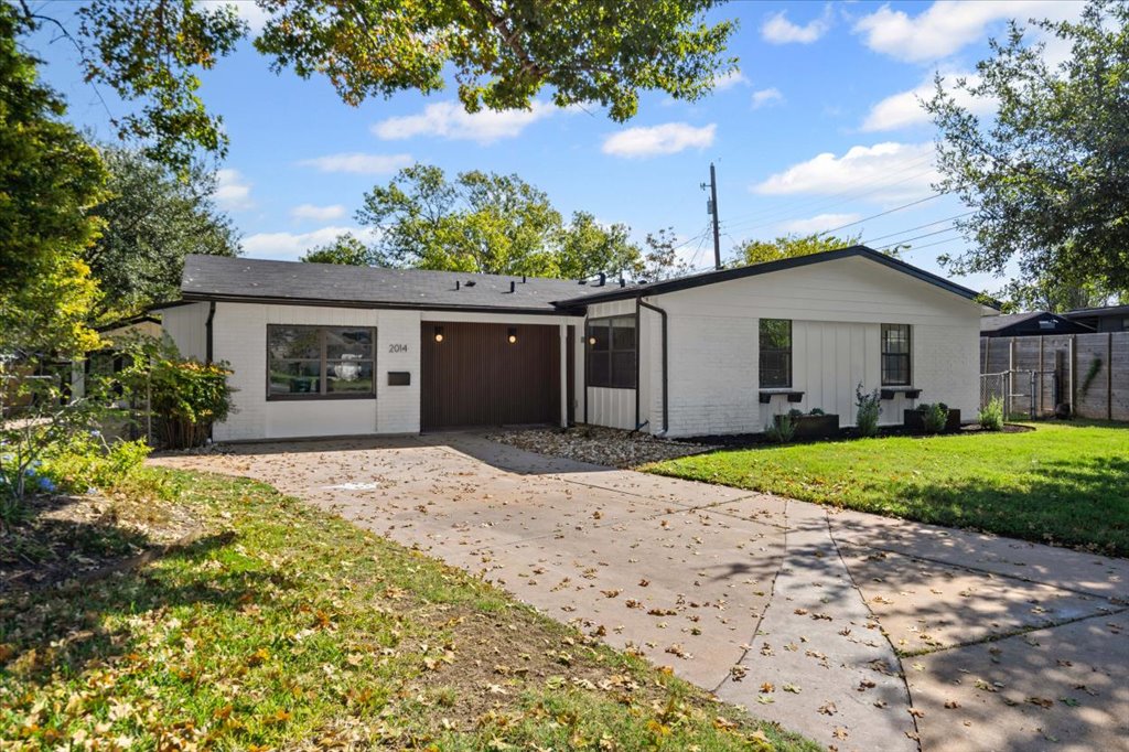 2014 Hardy Circle Austin, TX 78757 - Photo 4 of 34 a view of a house with a small yard and a large tree