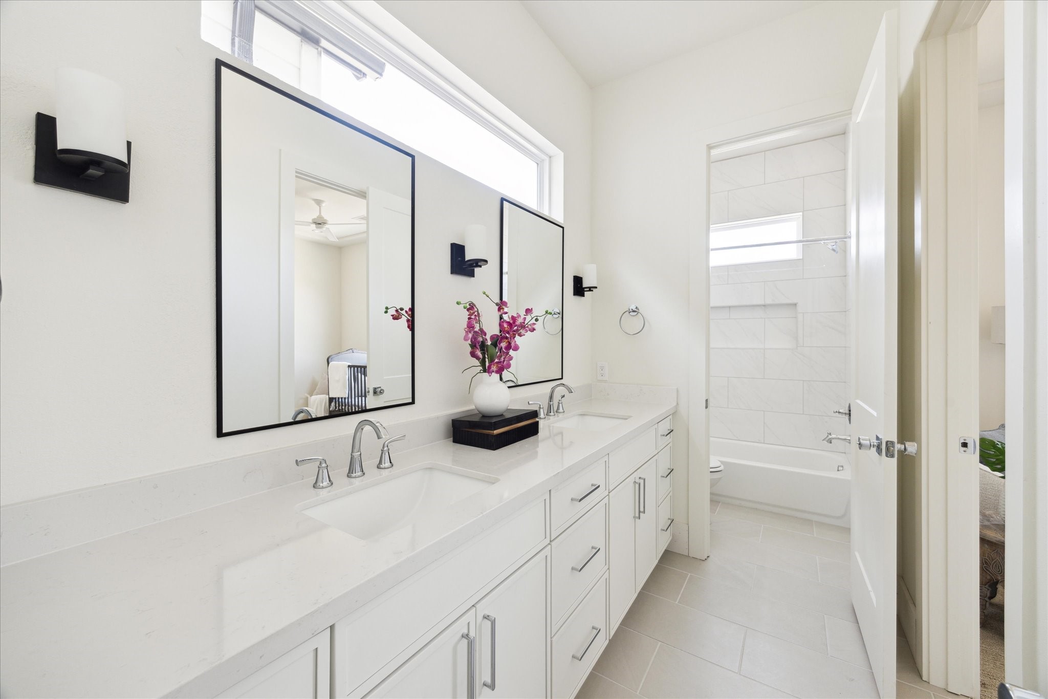 5307 Lambeth Riverside Drive Houston, TX 77091 - Photo 23 of 30 Well Organized - The Guest Bath features a double vanity with quartz countertop, under-mount sinks framed mirror flanked by a pair of wall sconces. Private toilet and bath.