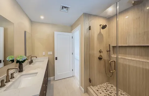 a bathroom with a shower sink and mirror
