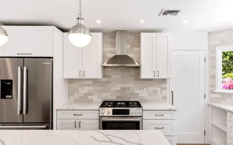 a kitchen with a stove a refrigerator and a sink