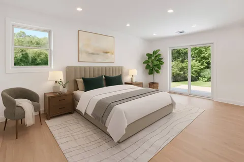 a bedroom with a large bed and a window