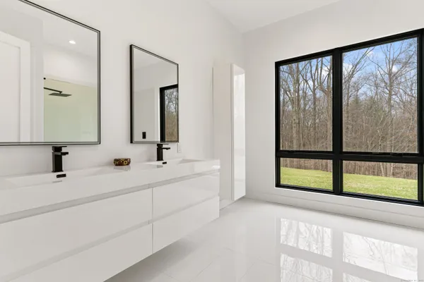 a bathroom with a double vanity sink and mirror