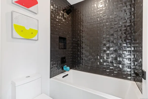 a bathroom with a bathtub and sink