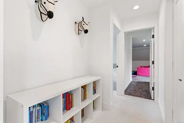 a living room with furniture and wall paintings