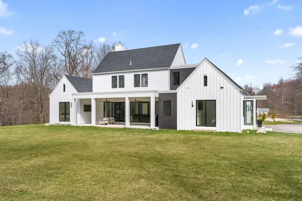 a view of a house with a yard and trees