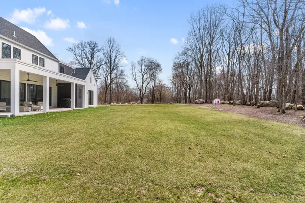 a view of a house with backyard and porch