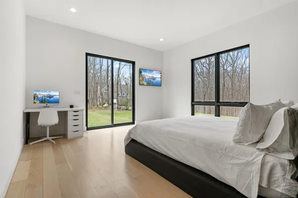 a bedroom with a bed and a large window