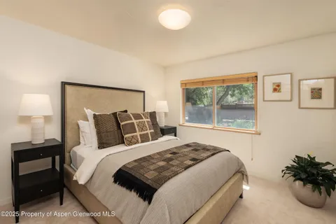 a bedroom with a large bed and a window