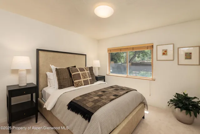 a bedroom with a large bed and a window