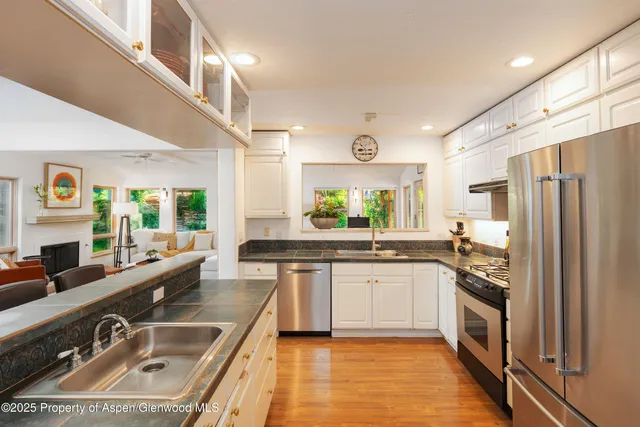a kitchen with stainless steel appliances a sink stove and refrigerator
