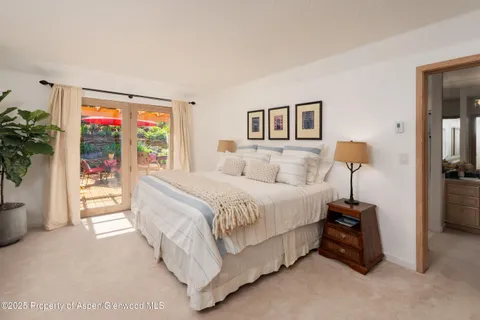 a bedroom with a bed and a potted plant
