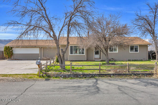 3440 Canvasback Lane Reno, NV 89508 - Photo 1 of 45 a front view of a house with a garden and trees