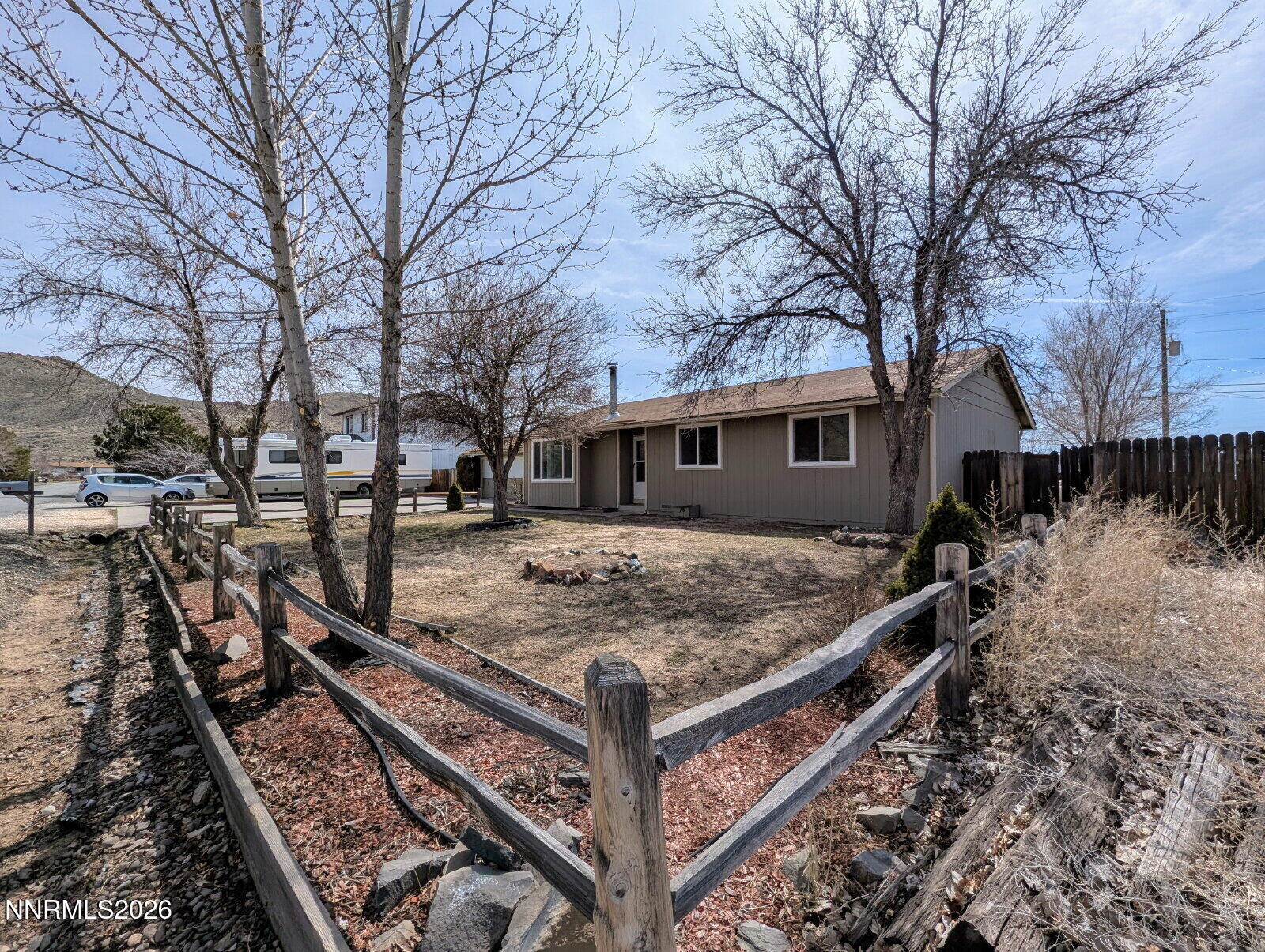 3440 Canvasback Lane Reno, NV 89508 - Photo 7 of 45 a view of a wooden house with a yard