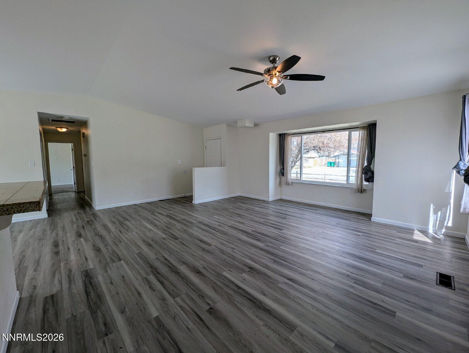 3440 Canvasback Lane Reno, NV 89508 - Photo 9 of 45 a view of empty room with wooden floor and fan