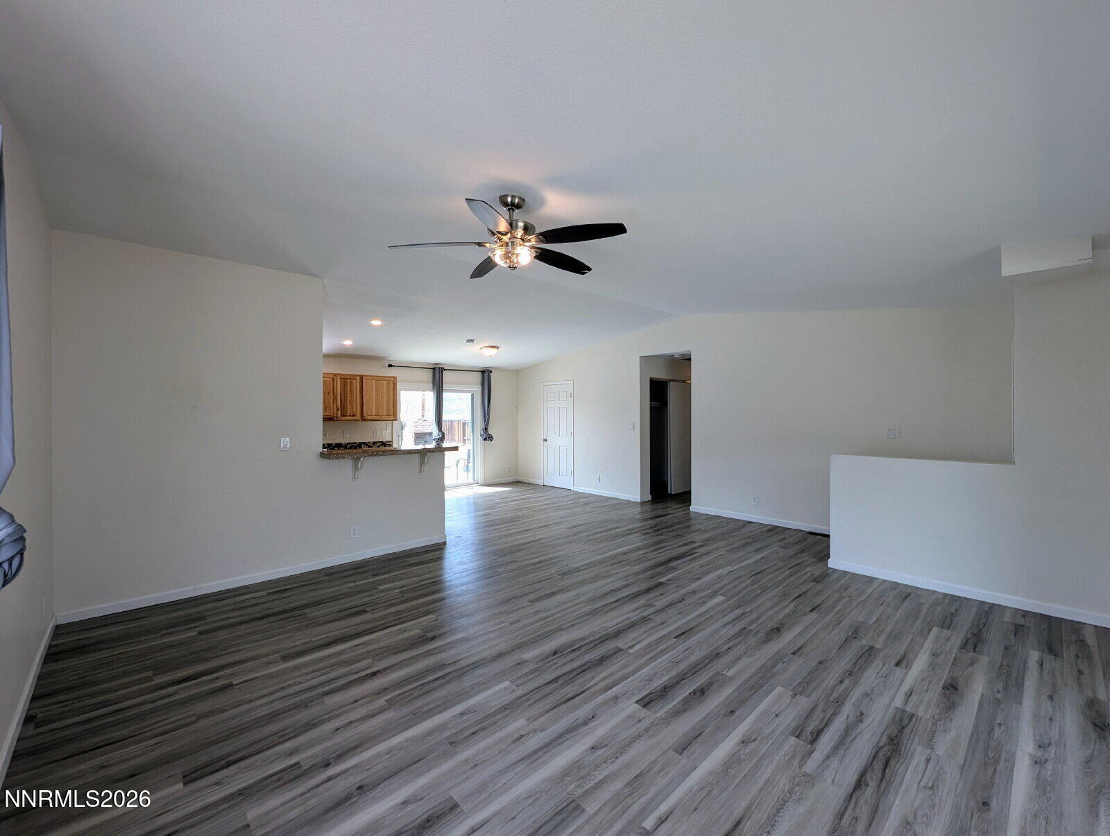 3440 Canvasback Lane Reno, NV 89508 - Photo 10 of 45 a view of an empty room with a window and wooden floor