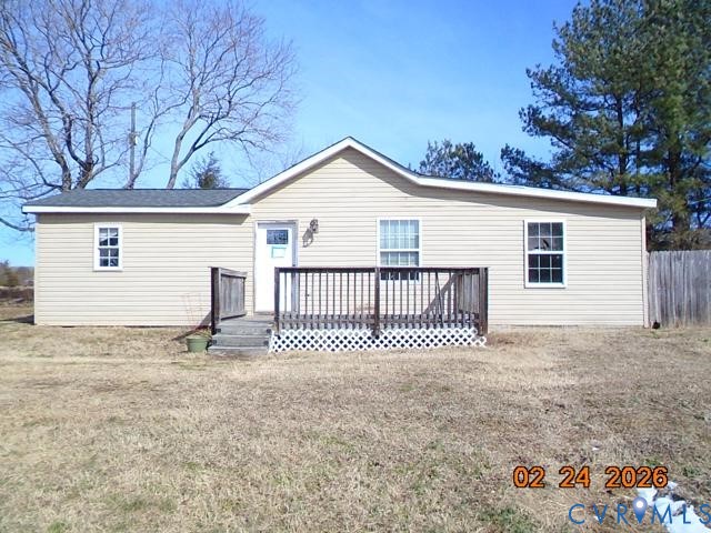 Rear view of property featuring a wooden deck