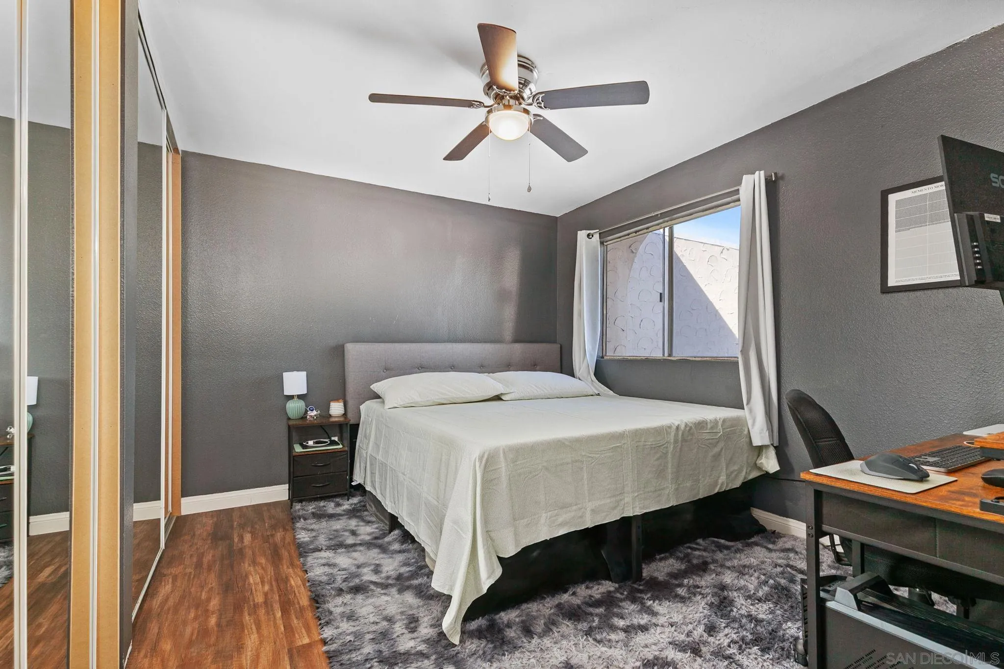 3557 Kenora Drive, Unit 6 Spring Valley, CA 91977 - Photo 11 of 33 a bedroom with a bed and a chandelier