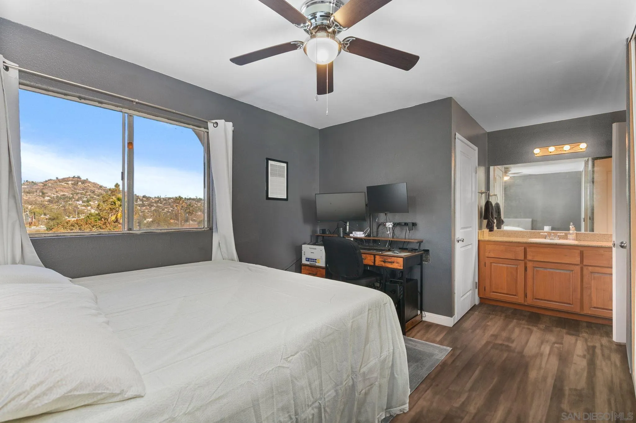 3557 Kenora Drive, Unit 6 Spring Valley, CA 91977 - Photo 12 of 33 a bedroom with a large bed and a flat tv screen