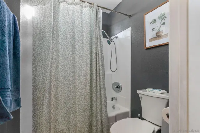 a white toilet sitting next to a bathroom sink