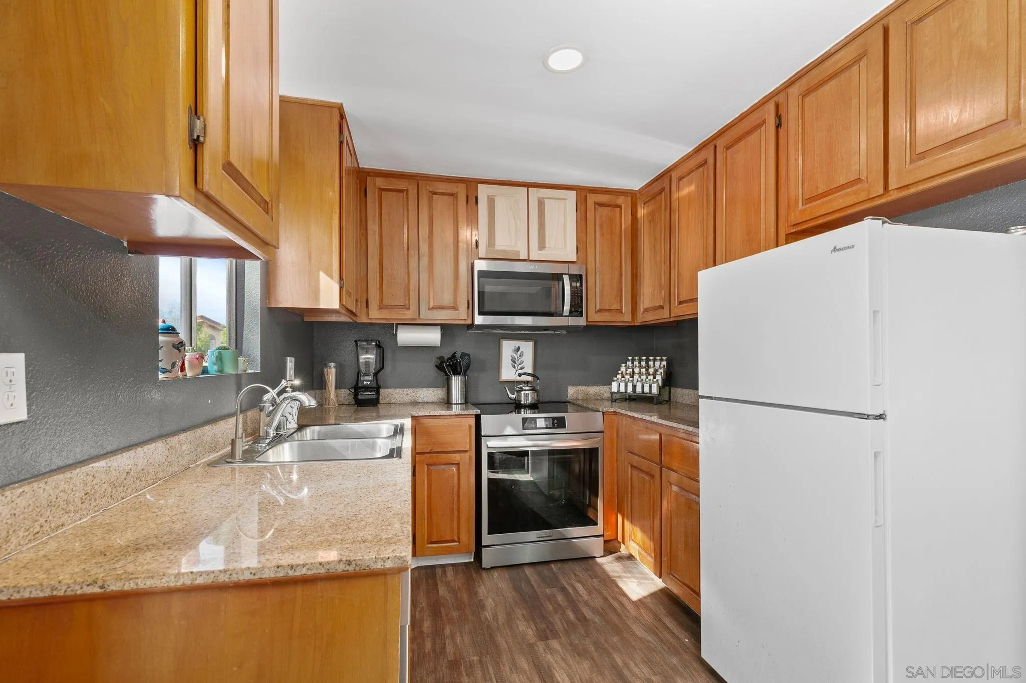 3557 Kenora Drive, Unit 6 Spring Valley, CA 91977 - Photo 2 of 33 a kitchen with granite countertop a refrigerator stove top oven and sink