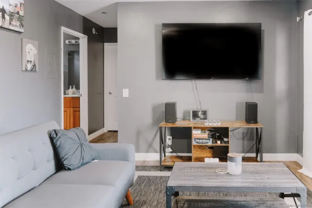 a living room with furniture and a flat screen tv