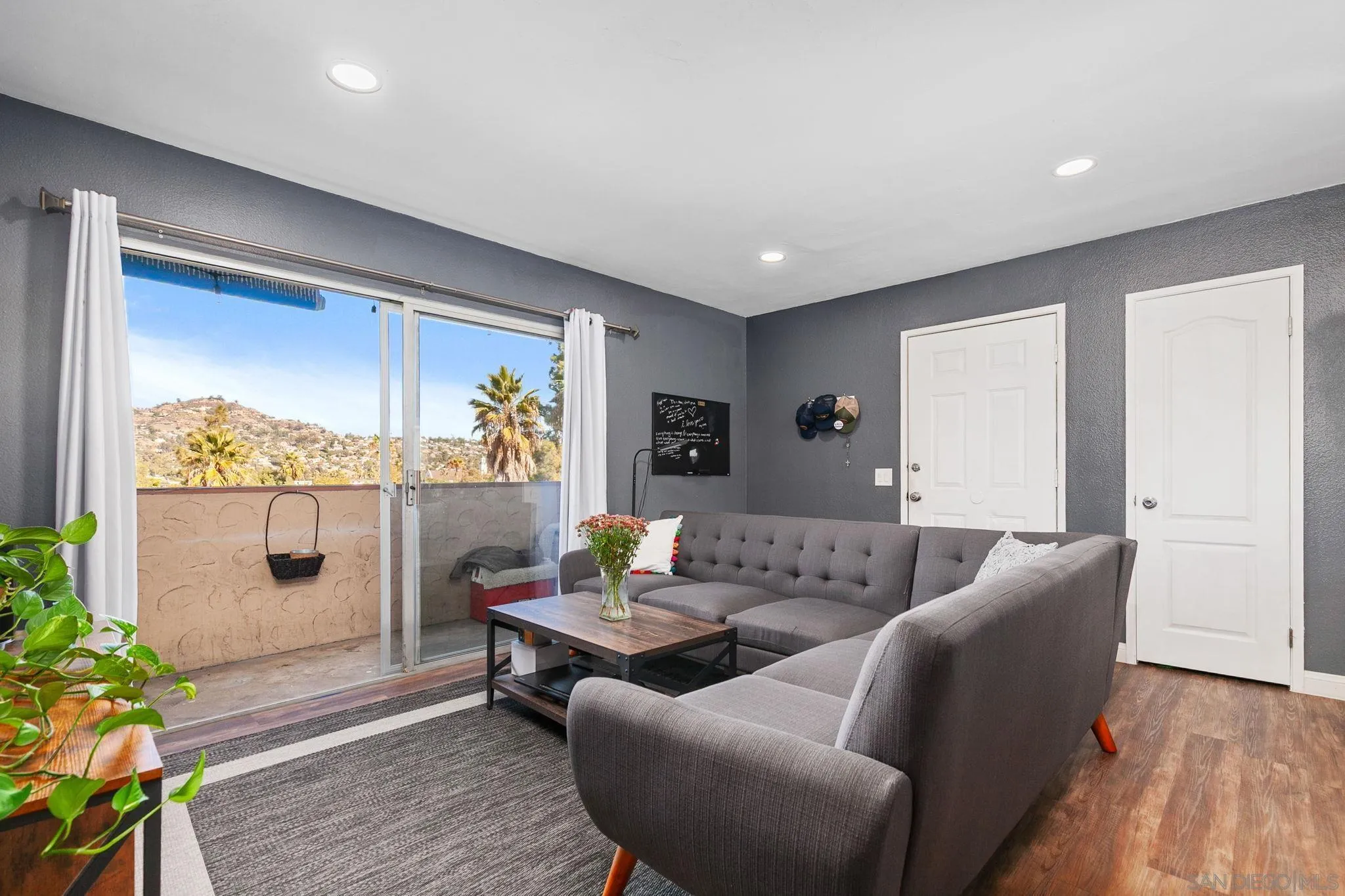 3557 Kenora Drive, Unit 6 Spring Valley, CA 91977 - Photo 7 of 33 a living room with furniture and wooden floor