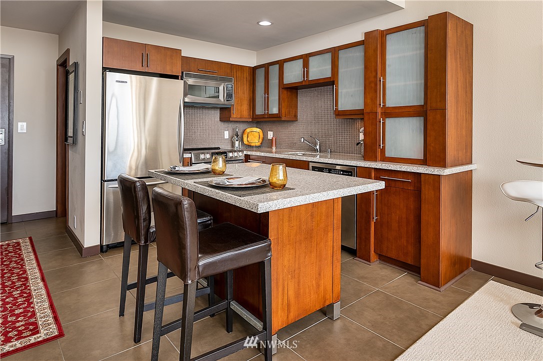 a kitchen with stainless steel appliances granite countertop a stove a refrigerator and a refrigerator