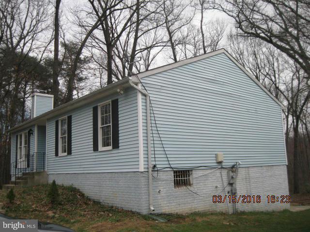 9239 Fowler Lane Lanham, MD 20706 - Photo 2 of 17 a view of a white house with a large tree