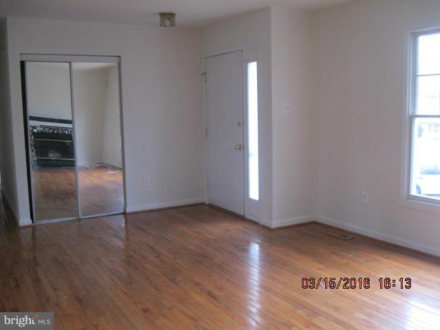 9239 Fowler Lane Lanham, MD 20706 - Photo 5 of 17 an empty room with wooden floor closet and windows