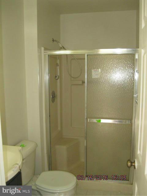 9239 Fowler Lane Lanham, MD 20706 - Photo 9 of 17 a bathroom with a toilet and a shower