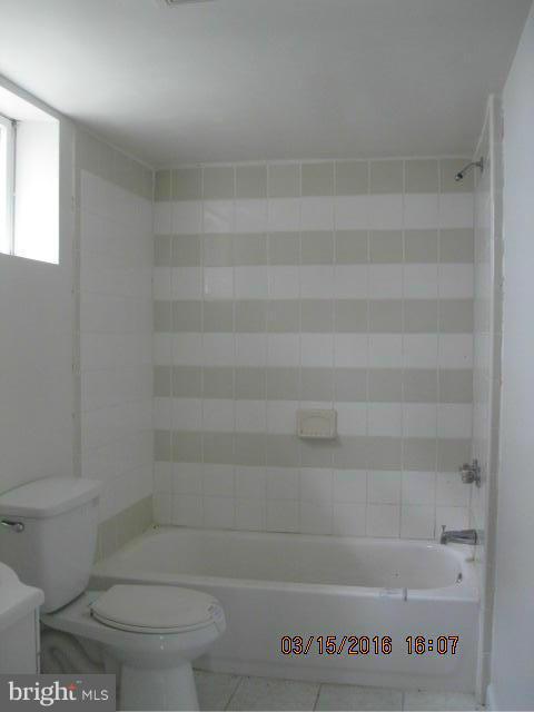 9239 Fowler Lane Lanham, MD 20706 - Photo 10 of 17 a bathroom with a toilet and a bathtub