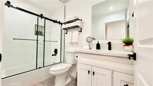 a bedroom with two beds and a night stand