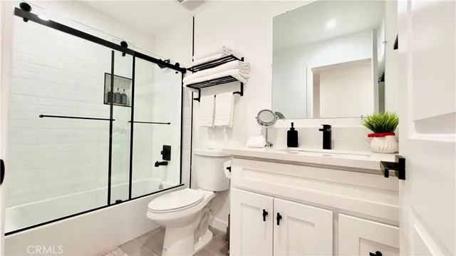 a bedroom with two beds and a night stand