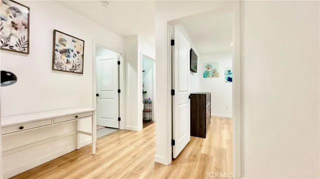 a bedroom with a bed a mirror next to a window