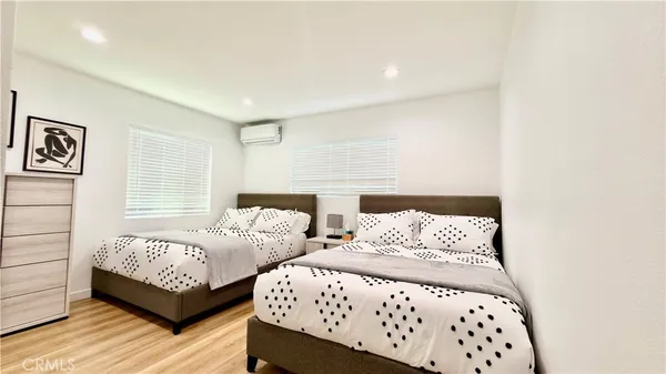 a bedroom with a bed and a painting on the wall