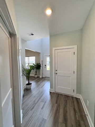 a view of a livingroom with wooden floor and a window