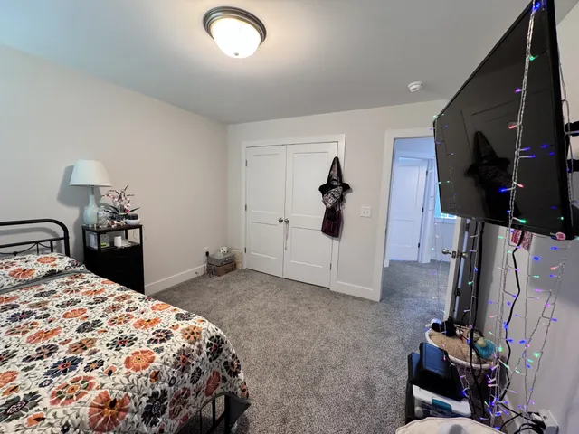 a bedroom with a bed and a flat tv screen