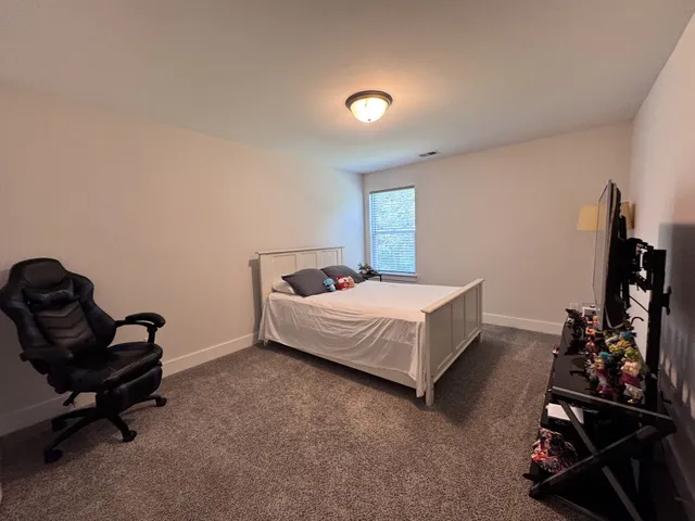 a bedroom with a bed and a chair